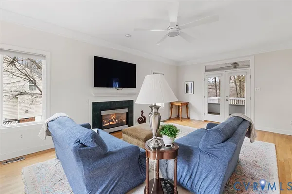 a living room with furniture a fireplace and a flat screen tv