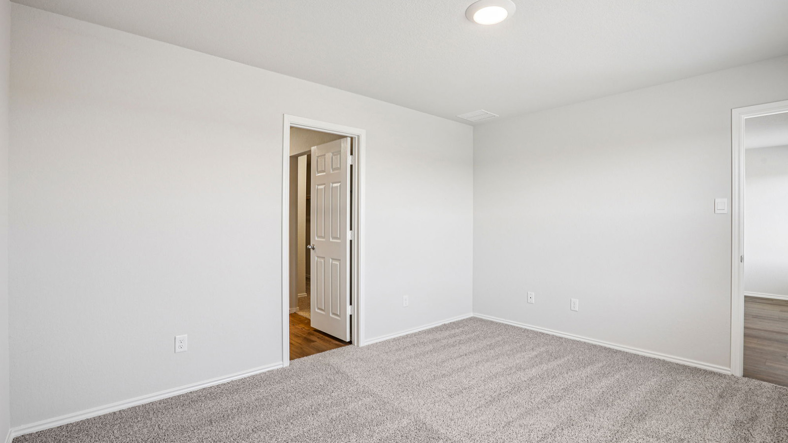 148 Wyatt Way Jarrell, TX 76537 - Photo 17 of 33 Spacious room featuring light gray wall paint, gray patterned carpet, a recessed ceiling light, and white trim