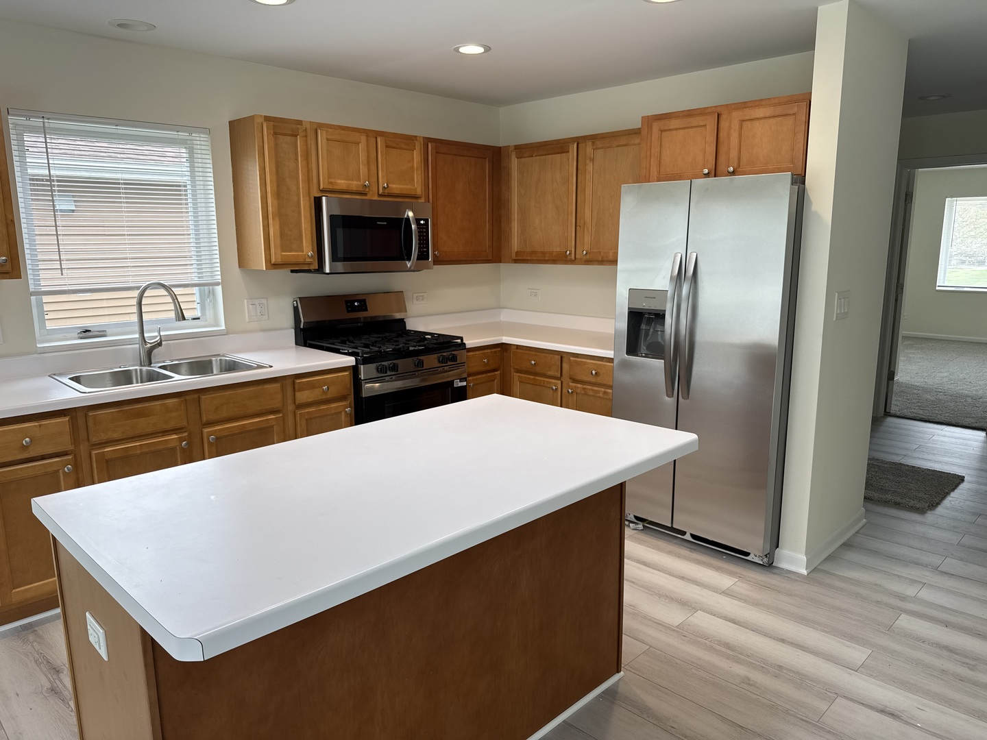 922 West Bergera Road Braidwood, IL 60408 - Photo 3 of 19 a kitchen with stainless steel appliances a refrigerator microwave stove sink and cabinets