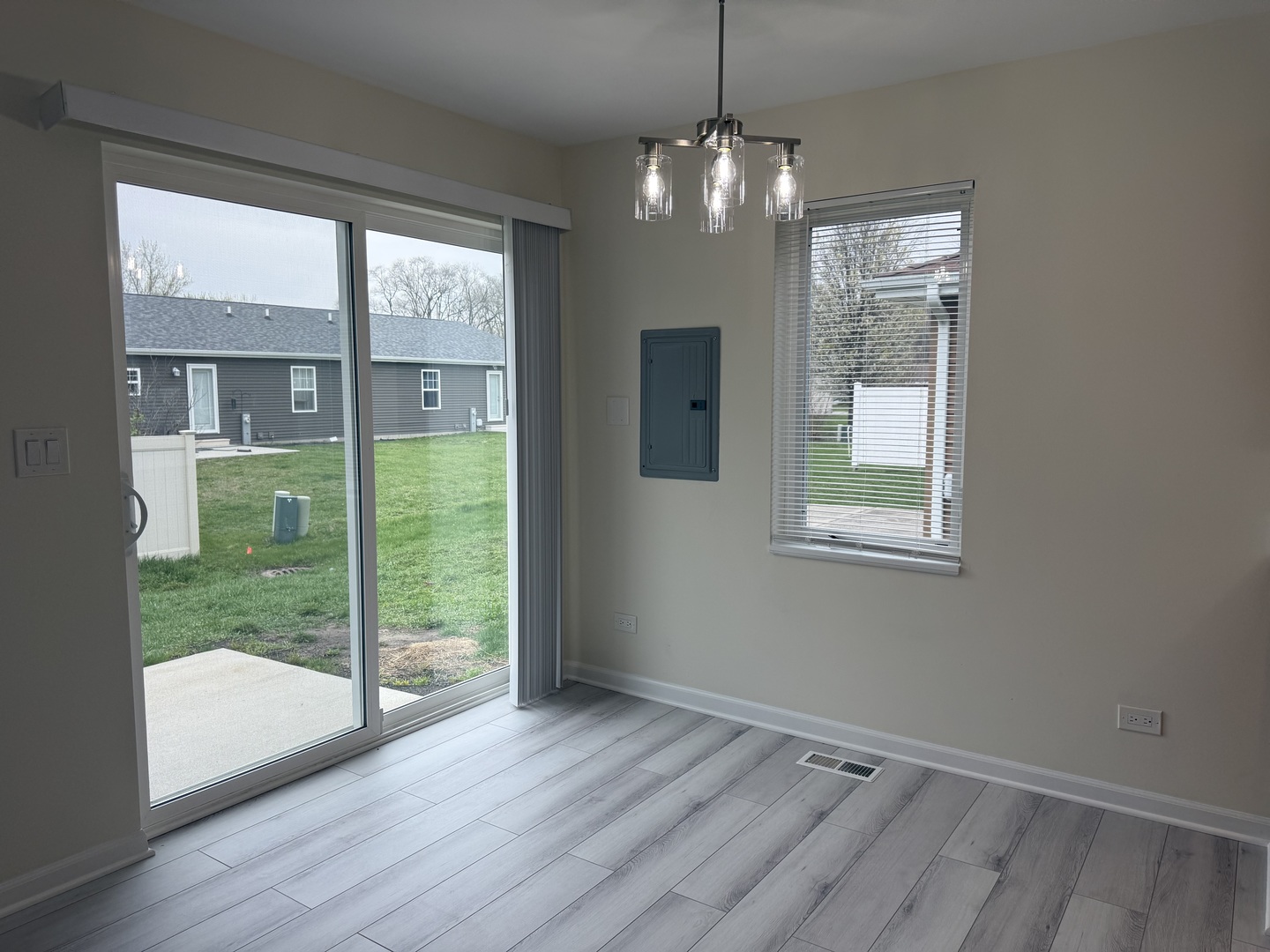 922 West Bergera Road Braidwood, IL 60408 - Photo 9 of 19 a view of an empty room with wooden floor and a window