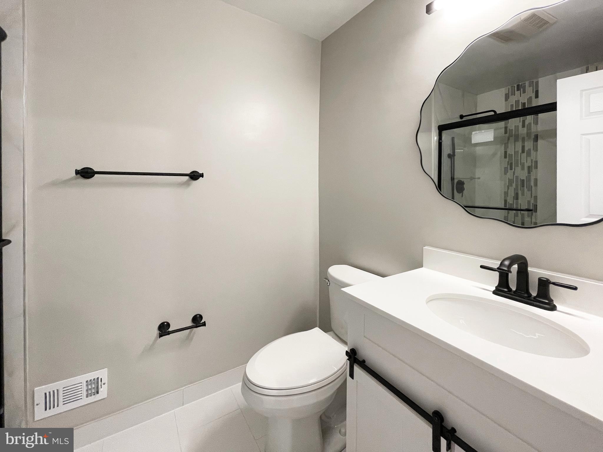 11968 Greywing Court Reston, VA 20191 - Photo 5 of 13 a bathroom with a sink toilet and mirror