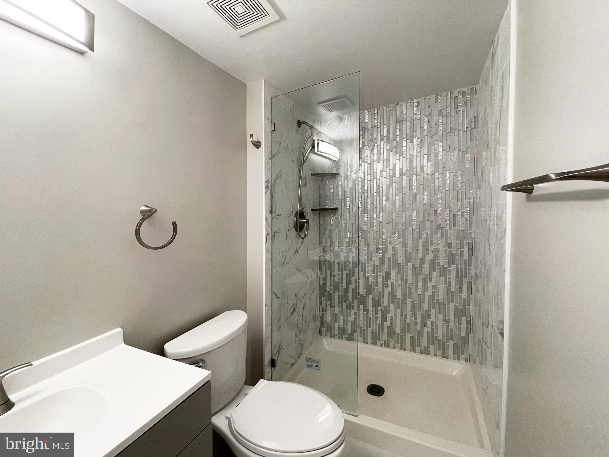 11968 Greywing Court Reston, VA 20191 - Photo 9 of 13 a bathroom with a shower a toilet and a sink