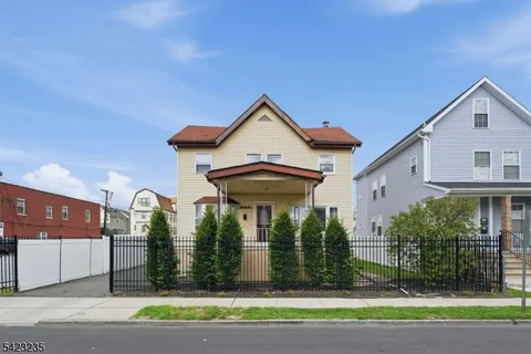 a view of a house with a yard and plants