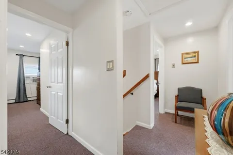 a bathroom with a toilet sink vanity and mirror