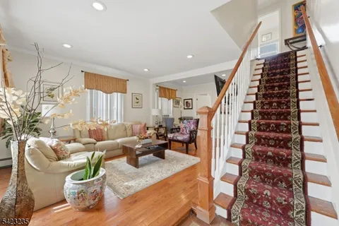 a living room with furniture and a chandelier
