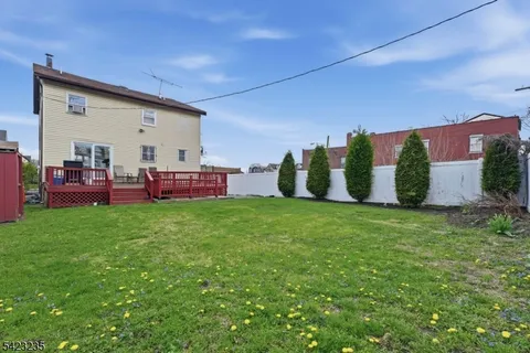 a bathroom with a granite countertop toilet sink and mirror