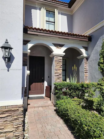 front view of a house with potted plants