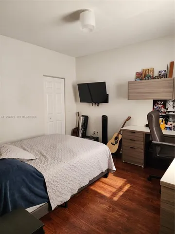 a kitchen with a refrigerator and a stove top oven