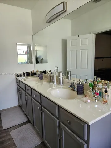 a bedroom with a bed lamp closet and window