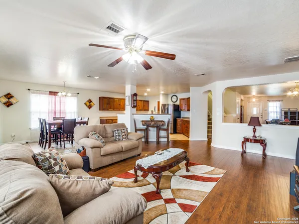 a living room with furniture and wooden floor