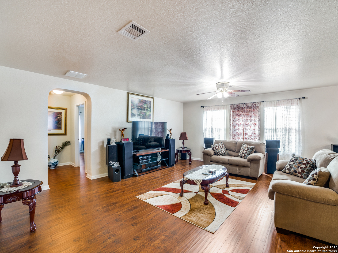 212 Springtree Trail Cibolo, TX 78108 - Photo 14 of 28 a living room with furniture and a flat screen tv with wooden floor