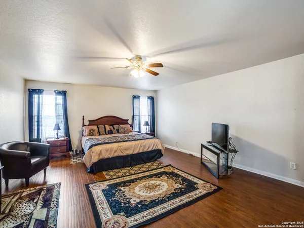 a bedroom with furniture and a rug