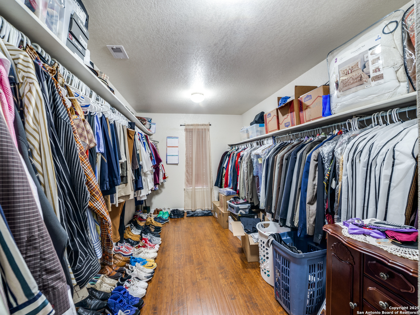 212 Springtree Trail Cibolo, TX 78108 - Photo 18 of 28 a view of walk in closet with clothes