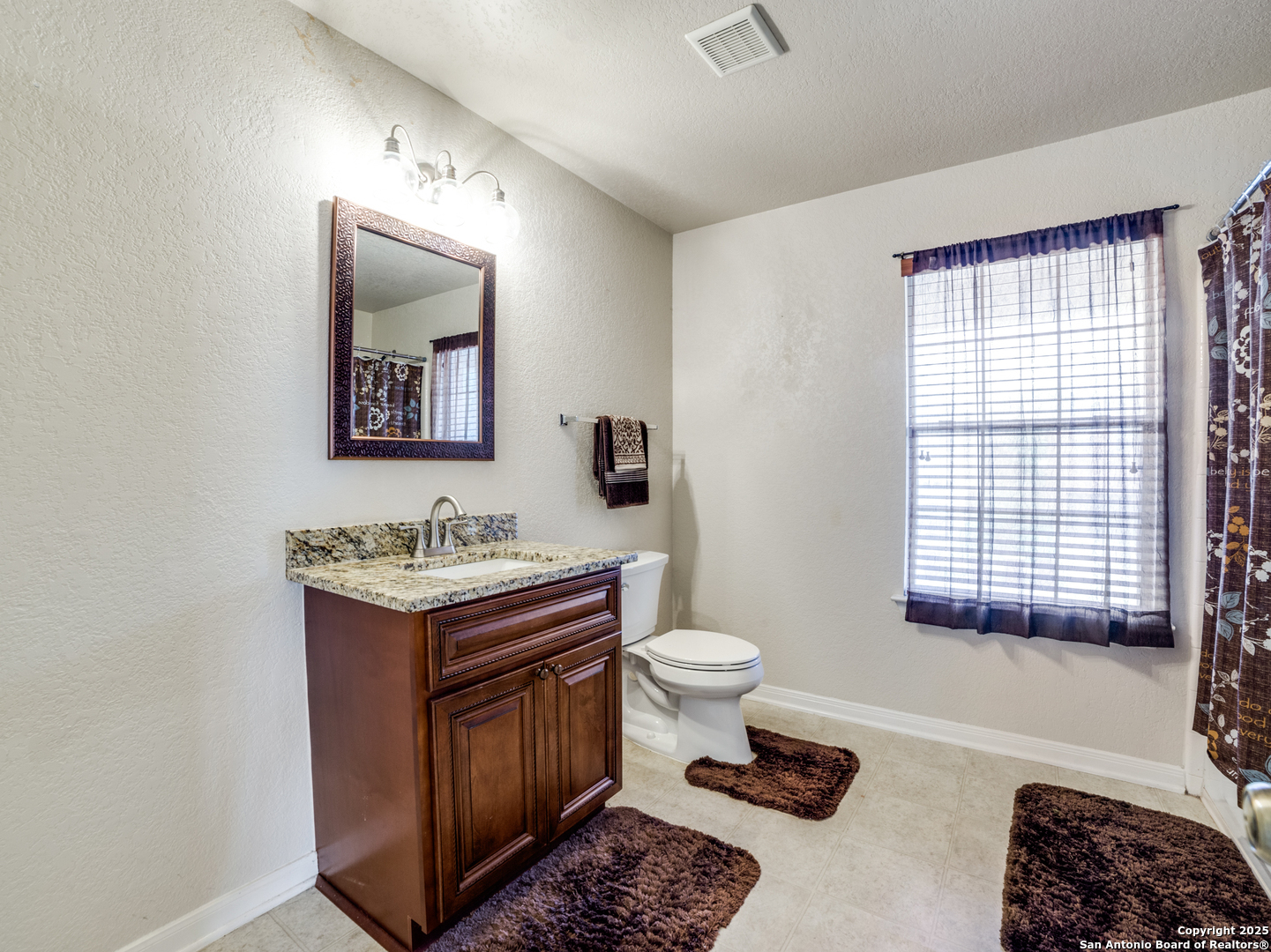 212 Springtree Trail Cibolo, TX 78108 - Photo 20 of 28 a bathroom with a toilet a sink and mirror