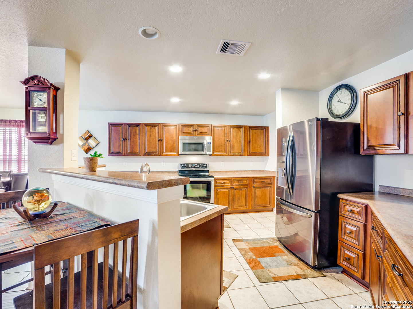 212 Springtree Trail Cibolo, TX 78108 - Photo 7 of 28 a kitchen with stainless steel appliances granite countertop a refrigerator and a stove top oven