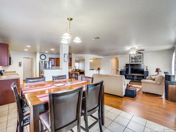 a dining room with a table chairs and a kitchen view