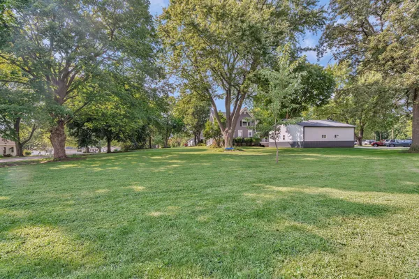 a view of a park with large trees