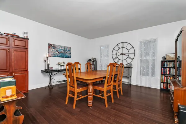 a view of a dining room with furniture and wooden floor