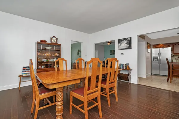 a dining room with furniture and wooden floor