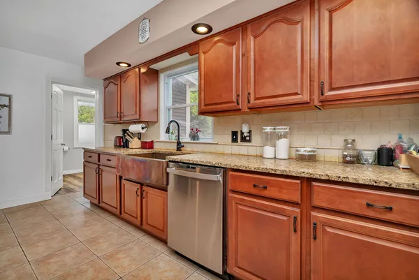 a kitchen with stainless steel appliances granite countertop a sink stove and cabinets
