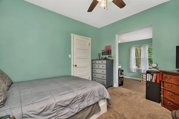 a bedroom with a bed and a television