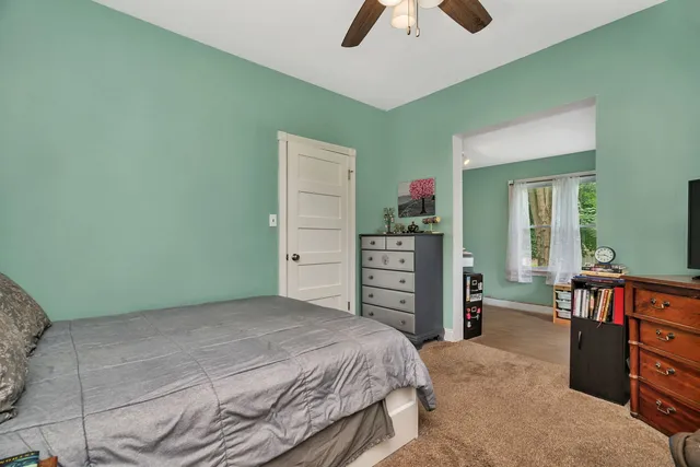 a bedroom with a bed and a television