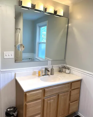 a bathroom with a sink and a mirror