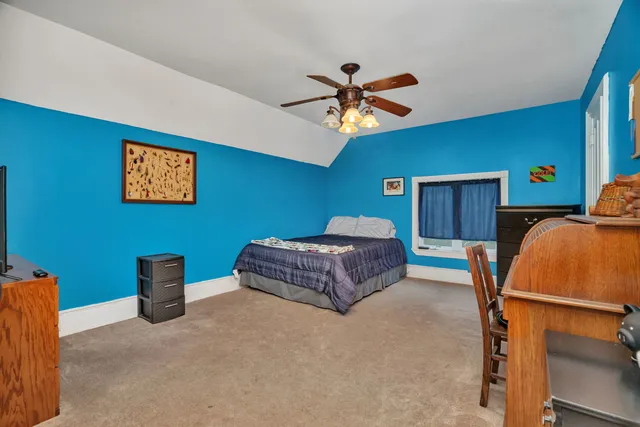 a bedroom with a bed and a chandelier