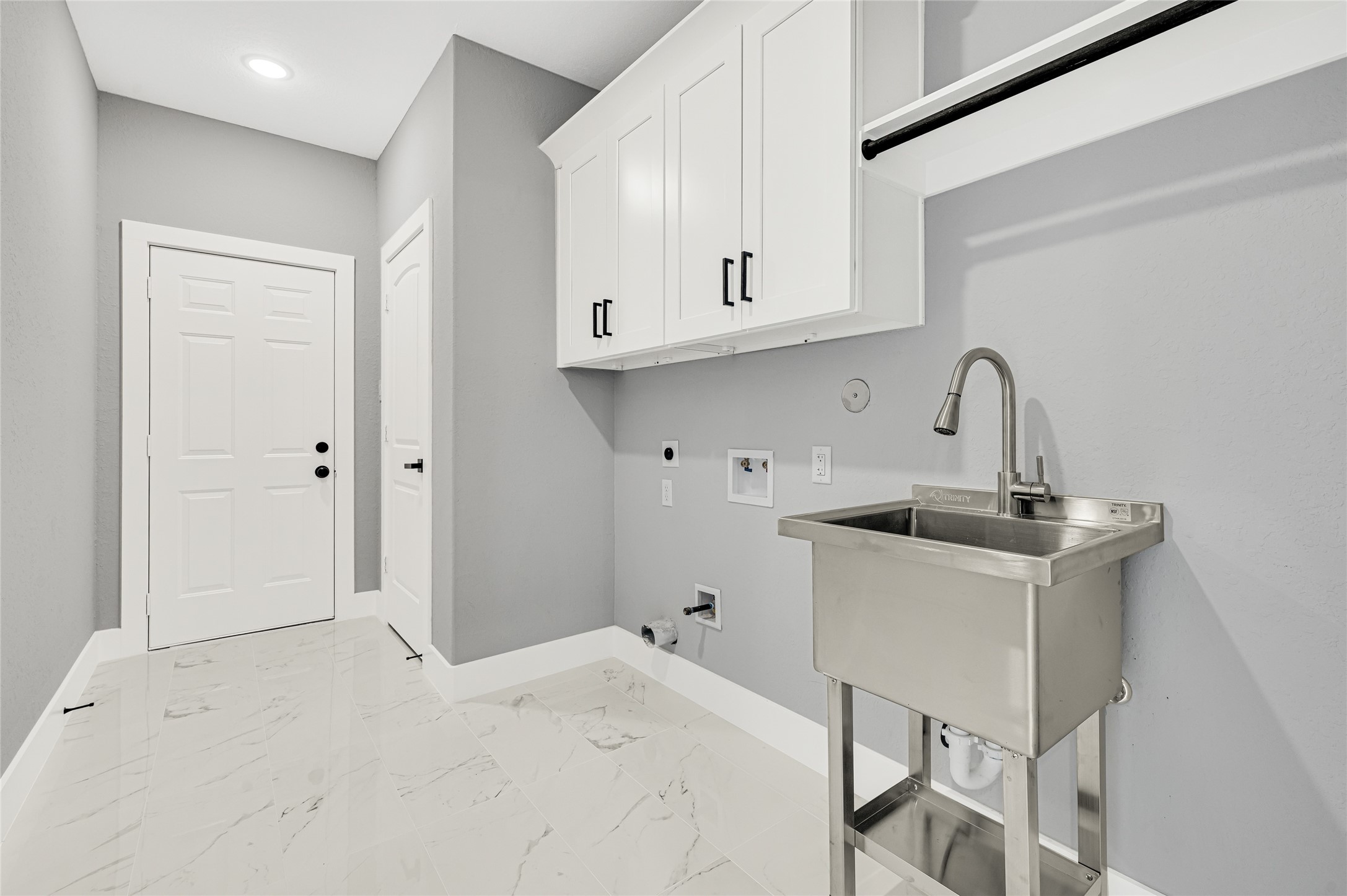 5930 Boness Road, Unit A & B Houston, TX 77396 - Photo 18 of 43 Spacious laundry room featuring ample cabinet storage and a convenient utility sink.