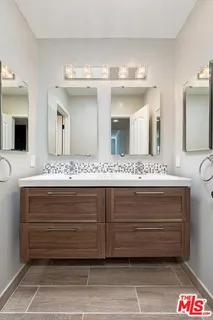 a bathroom with a sink double vanity and a mirror