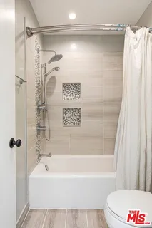 a bathroom with a shower and a bath tub