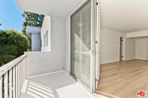 a view of a door and wooden floor in front of house