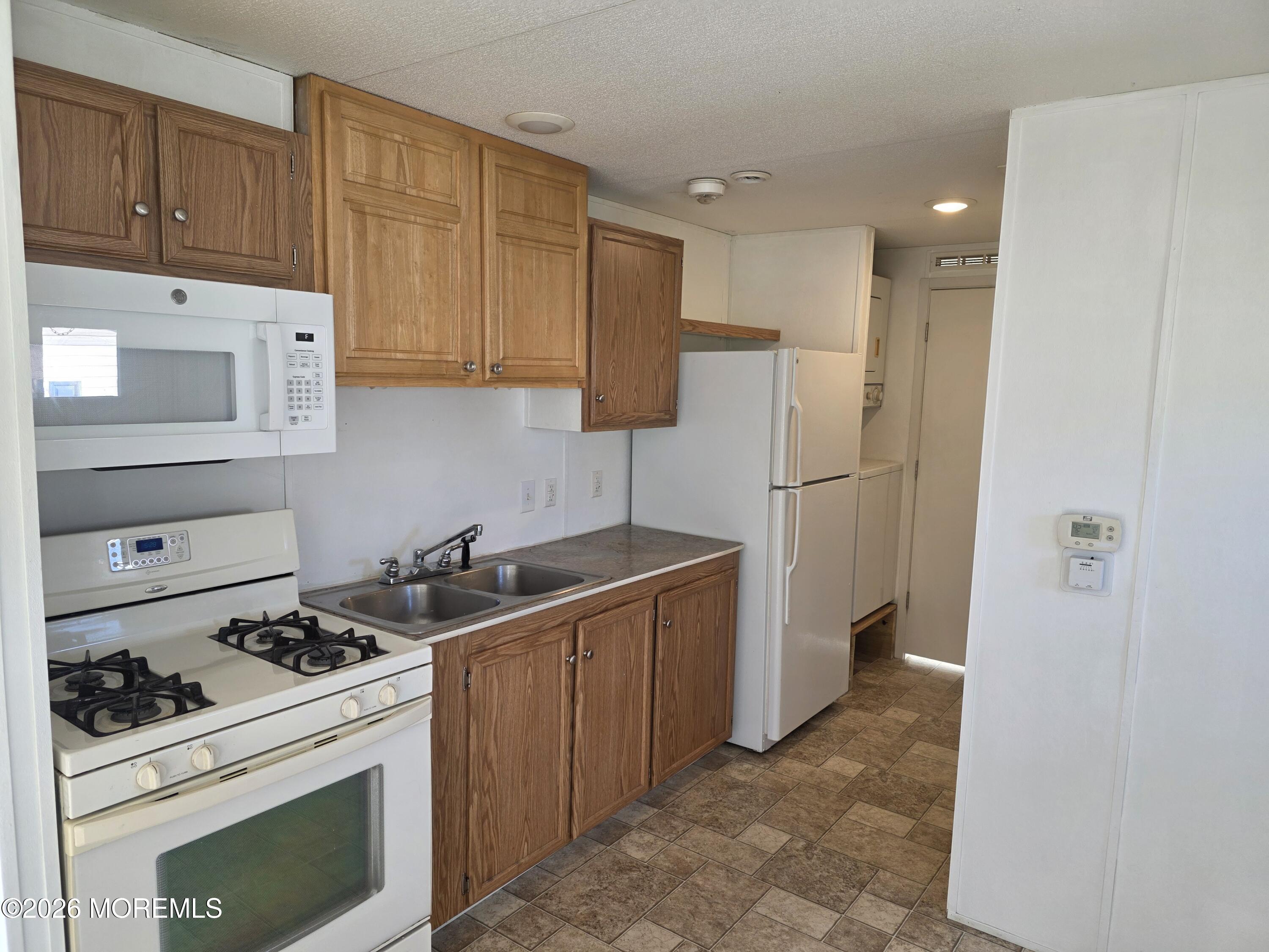 469 South Green Street, Unit 55 Tuckerton, NJ 08087 - Photo 3 of 7 a kitchen with a stove and a refrigerator