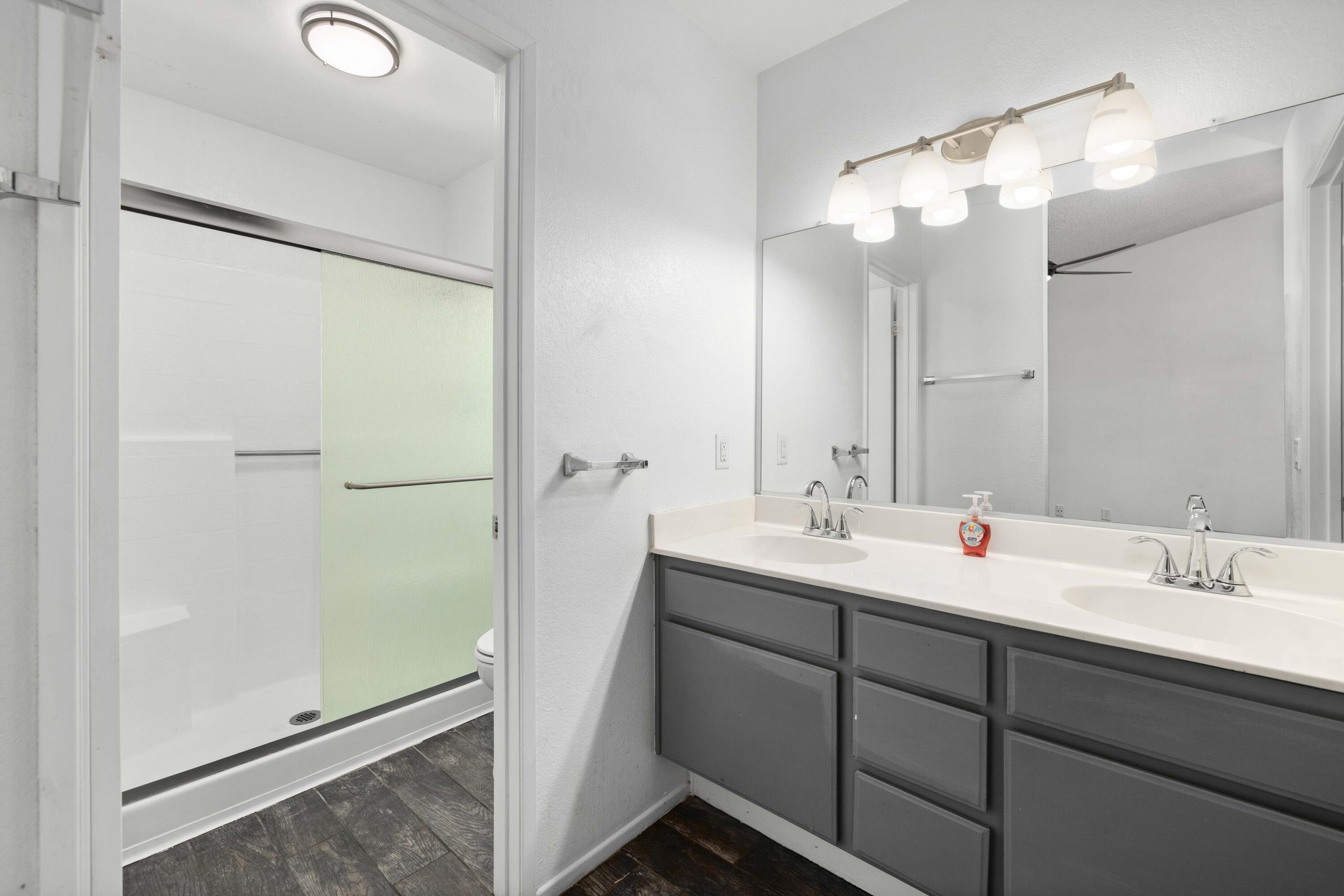 3043 Echo Drive Rosamond, CA 93560 - Photo 14 of 24 a bathroom with a double vanity sink mirror and double