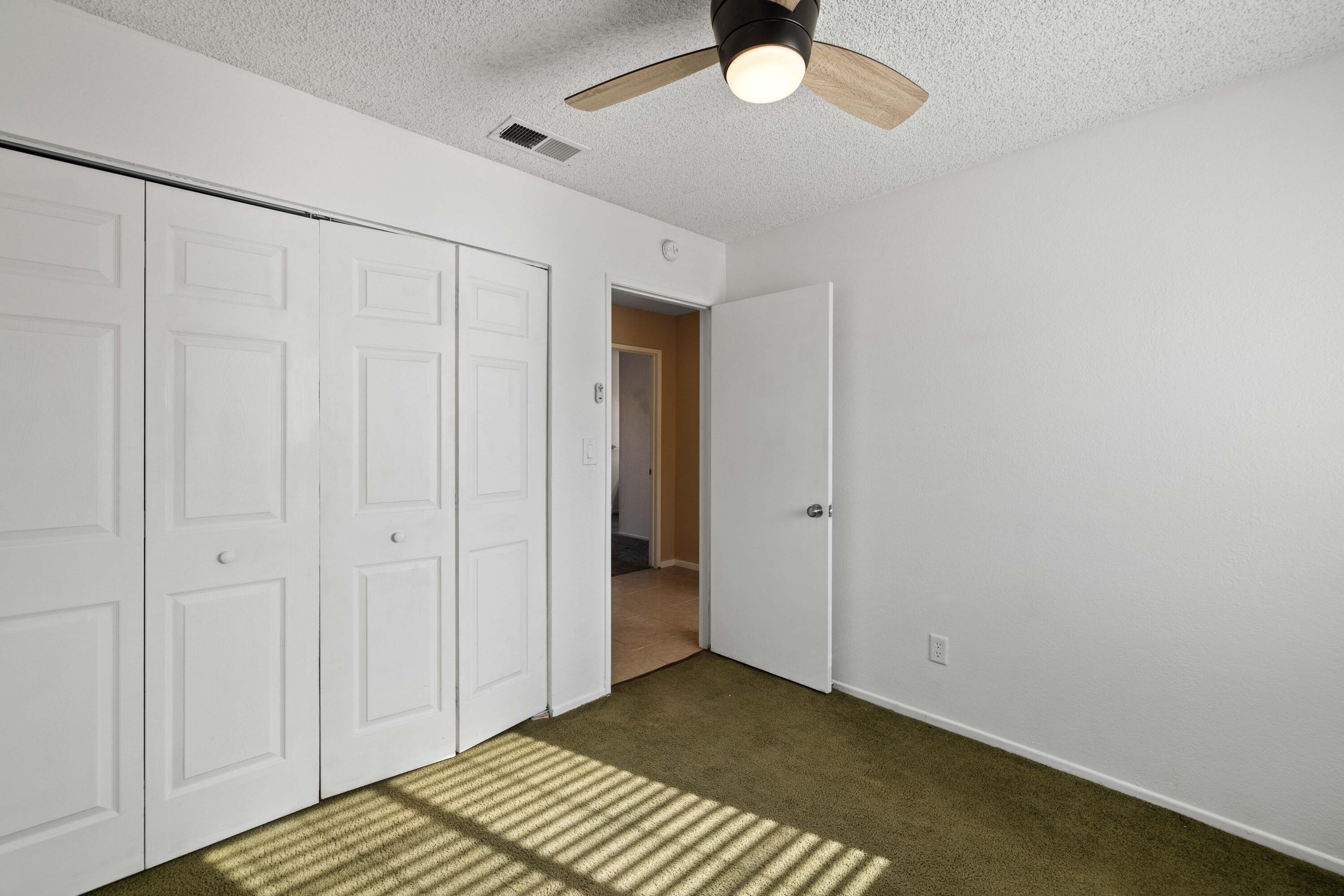 3043 Echo Drive Rosamond, CA 93560 - Photo 16 of 24 a view of a room with a chandelier fan and wooden floor