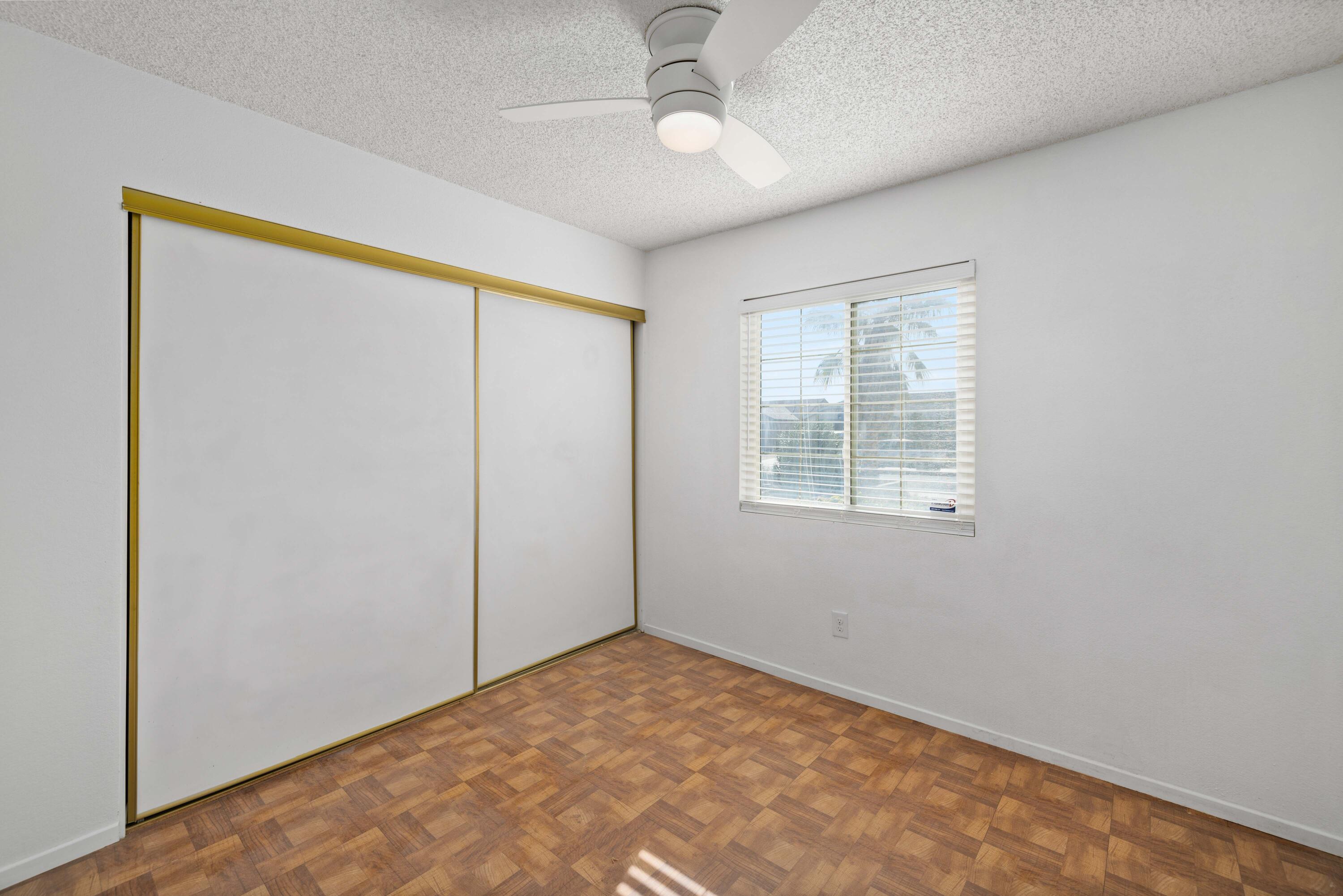 3043 Echo Drive Rosamond, CA 93560 - Photo 17 of 24 an empty room with windows and closet