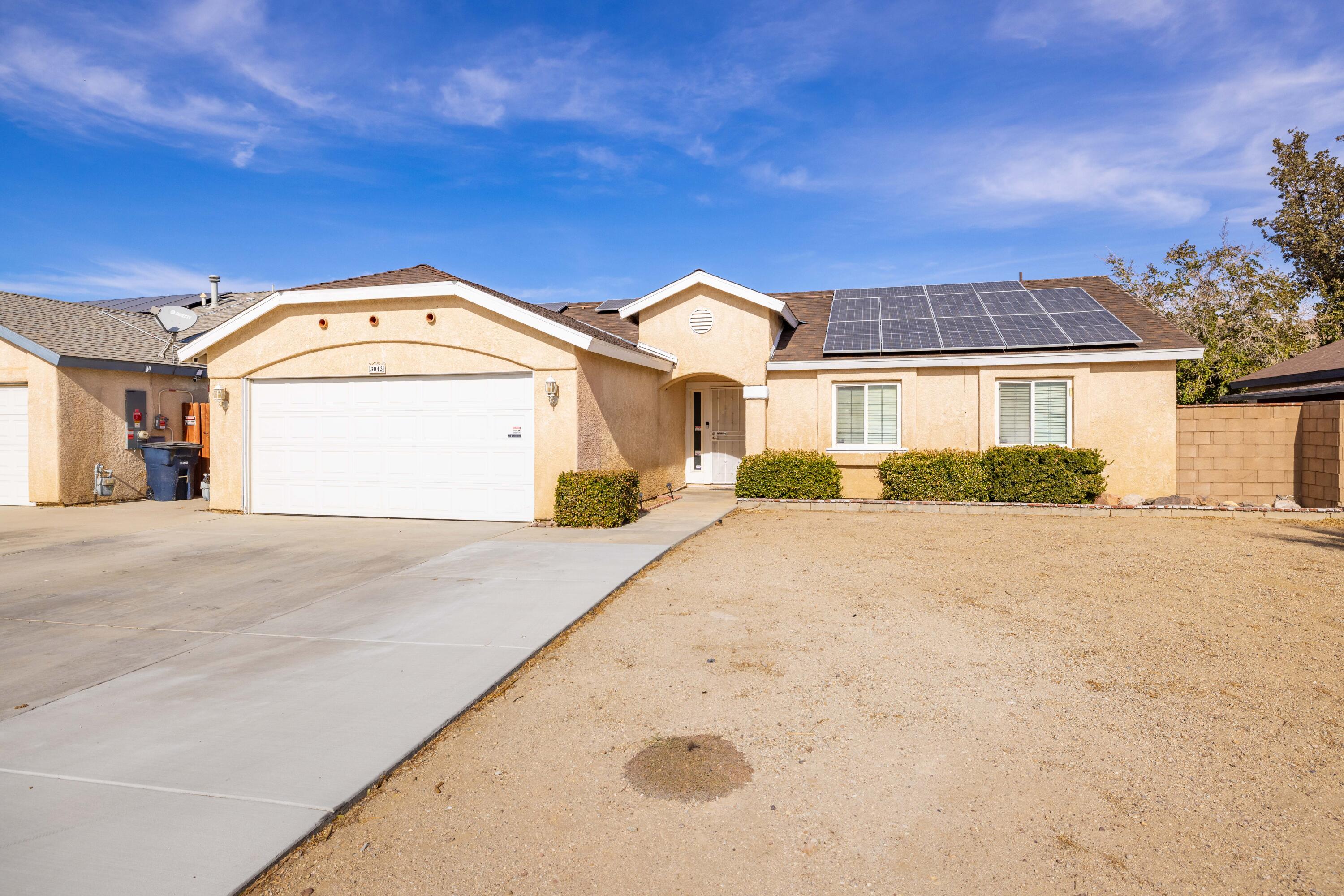 3043 Echo Drive Rosamond, CA 93560 - Photo 2 of 24 a front view of a house with a yard