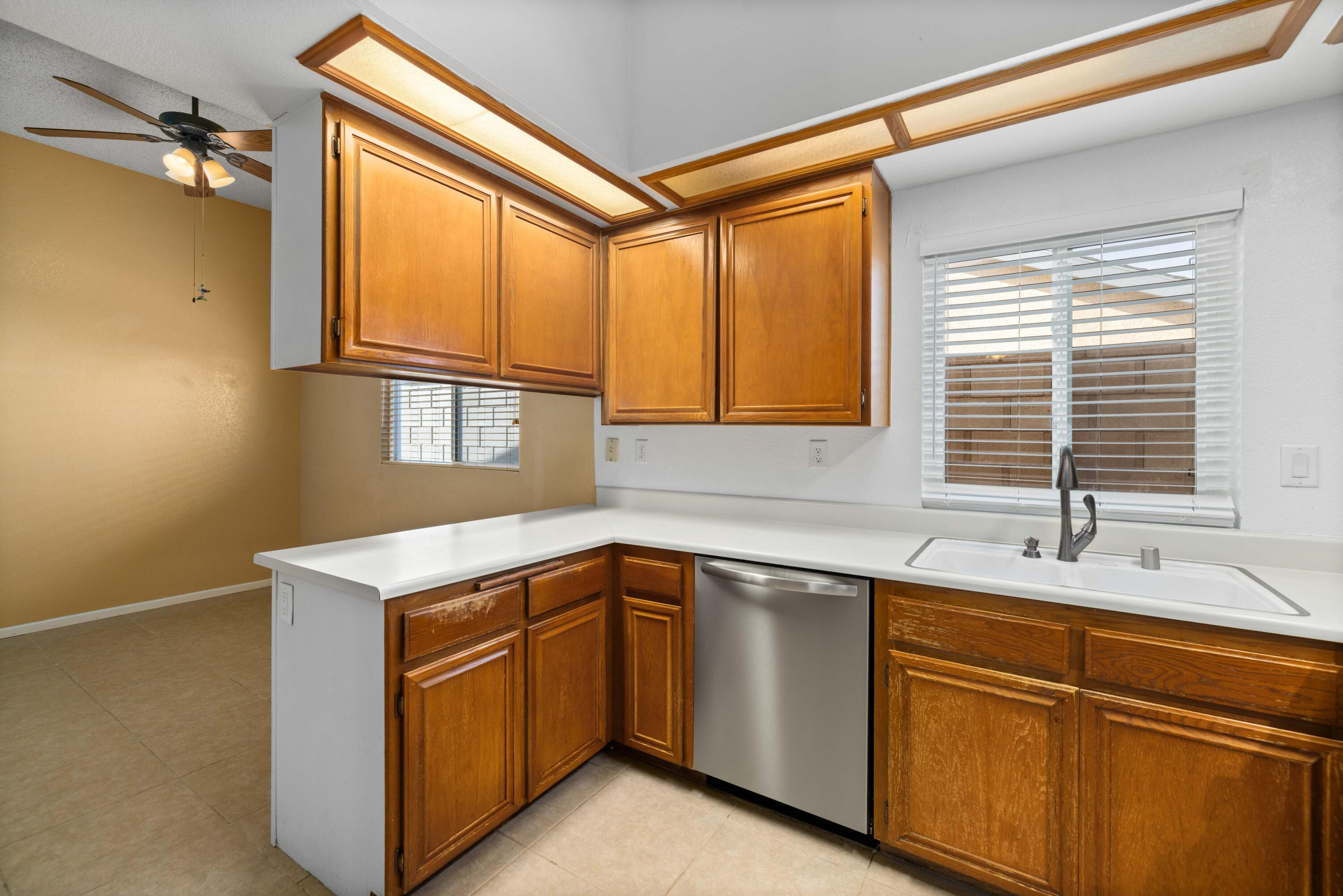 3043 Echo Drive Rosamond, CA 93560 - Photo 7 of 24 a kitchen with a sink cabinets and window