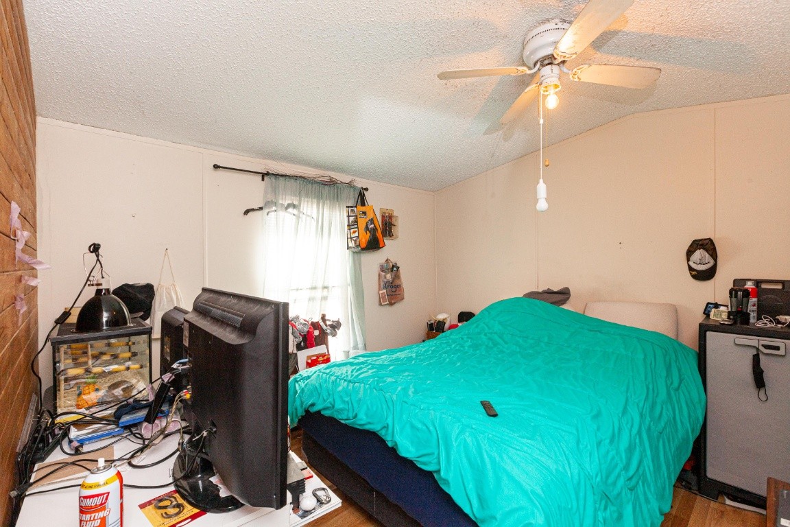 9312 Missionary Ridge Road Bon Aqua, TN 37025 - Photo 21 of 42 a bedroom with bed and a chandelier