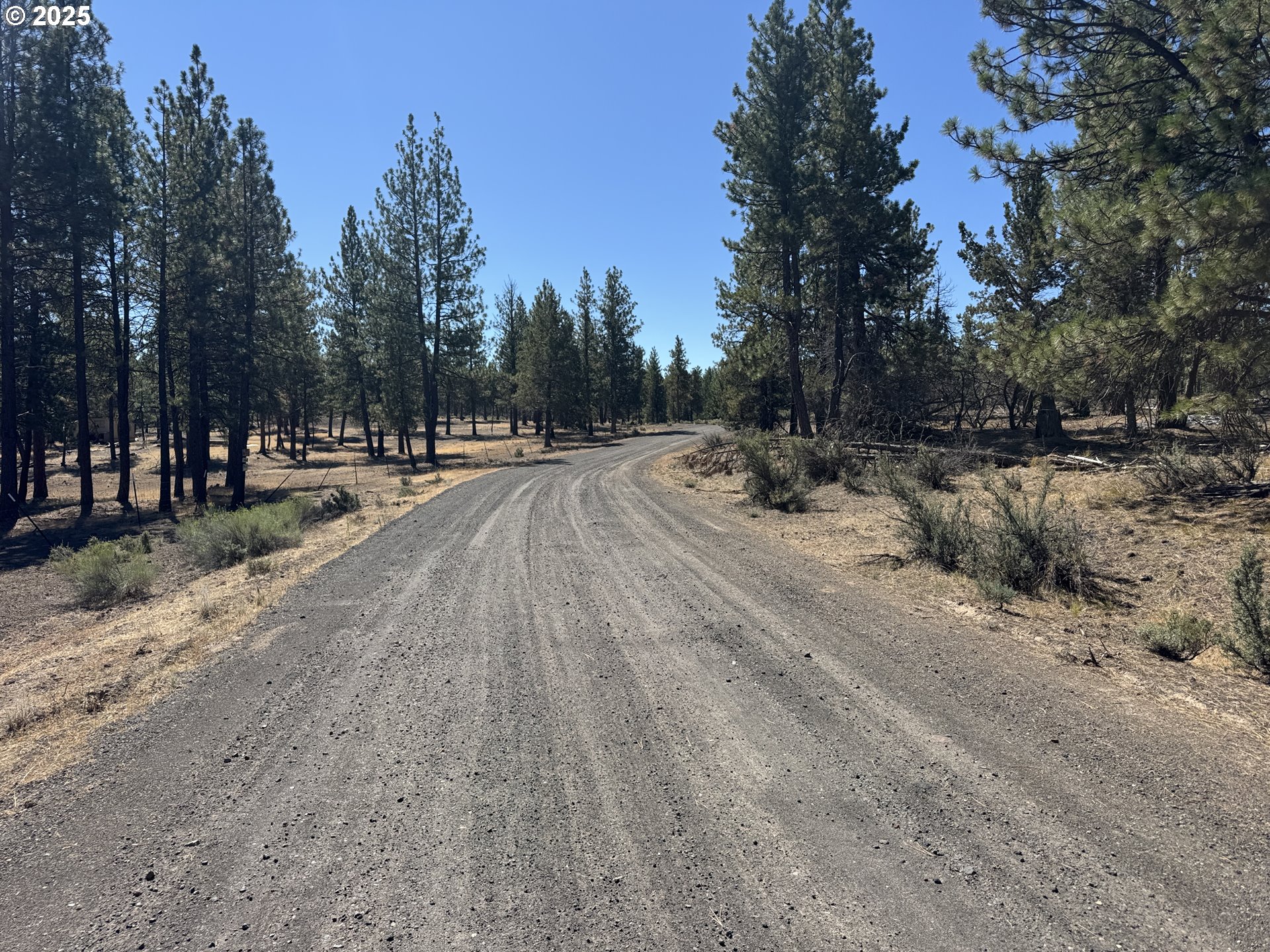 32818 Jean Street Chiloquin, OR 97624 - Photo 5 of 37 a view of a dirt road with a building in the background