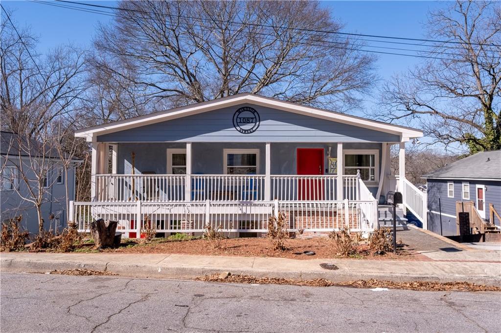1087 Windsor Street Southwest Atlanta, GA 30310 - Photo 1 of 1 a front view of a house with a yard