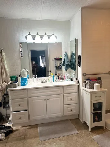 a bathroom with a sink vanity and a mirror