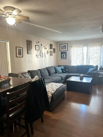 a living room with furniture and a piano