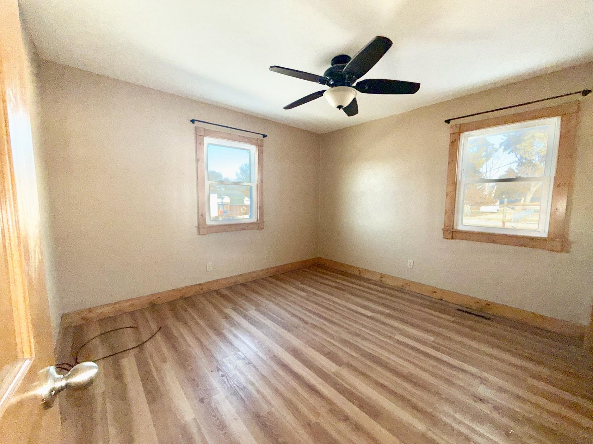 716 Viaduct Road Savanna, IL 61074 - Photo 13 of 19 a view of empty room with wooden floor and fan
