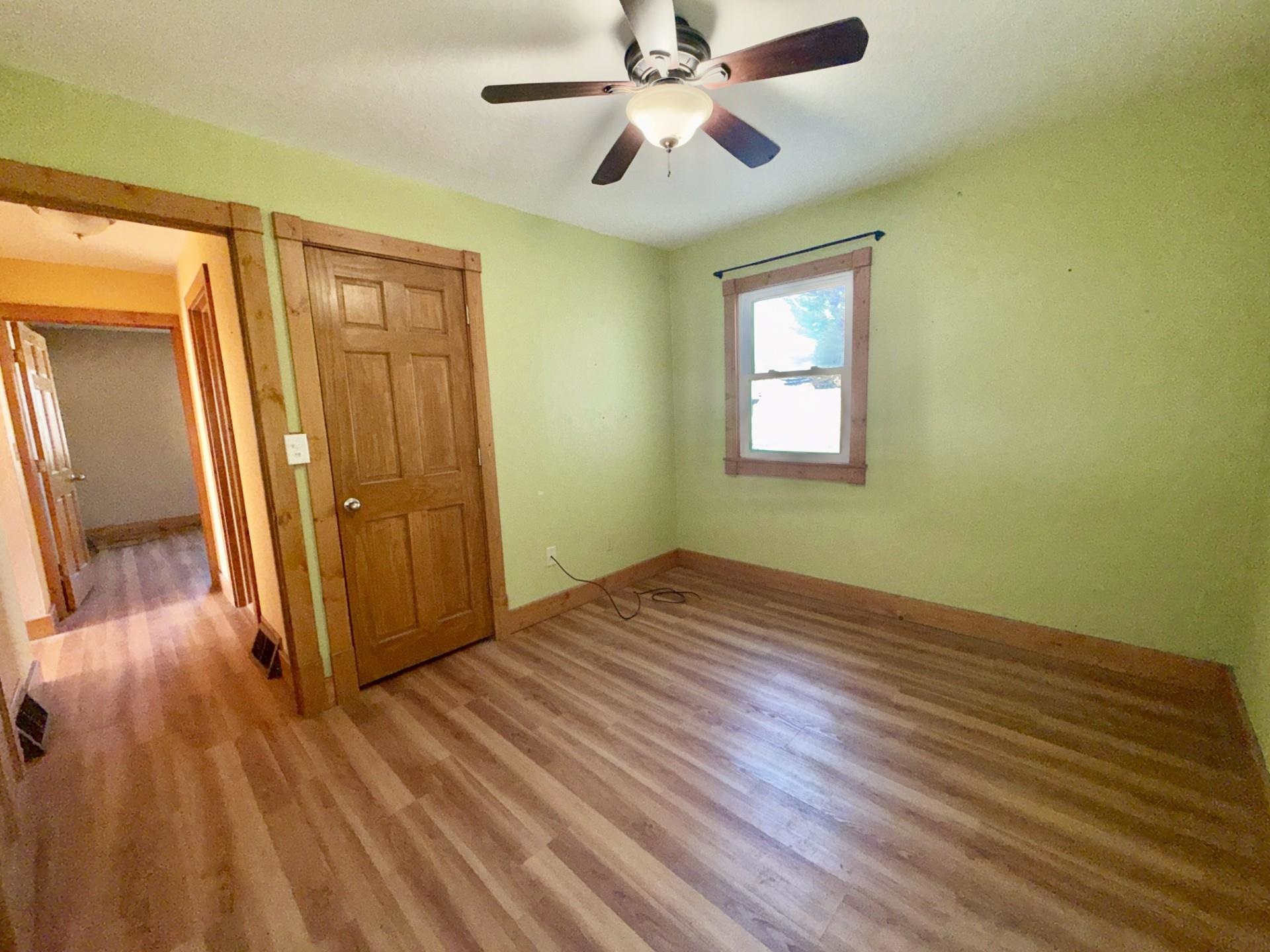 716 Viaduct Road Savanna, IL 61074 - Photo 9 of 19 wooden floor in an empty room with a window
