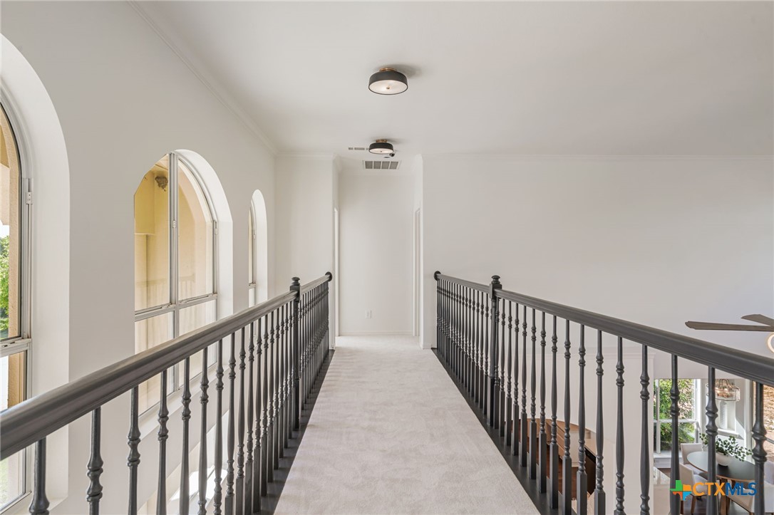 200 Tovas Secret Cove Georgetown, TX 78628 - Photo 18 of 31 a view of a hallway with wooden floor