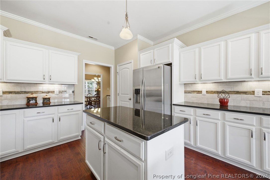 2589 June Johnson Road Raeford, NC 28376 - Photo 12 of 49 a kitchen with white cabinets and stainless steel appliances