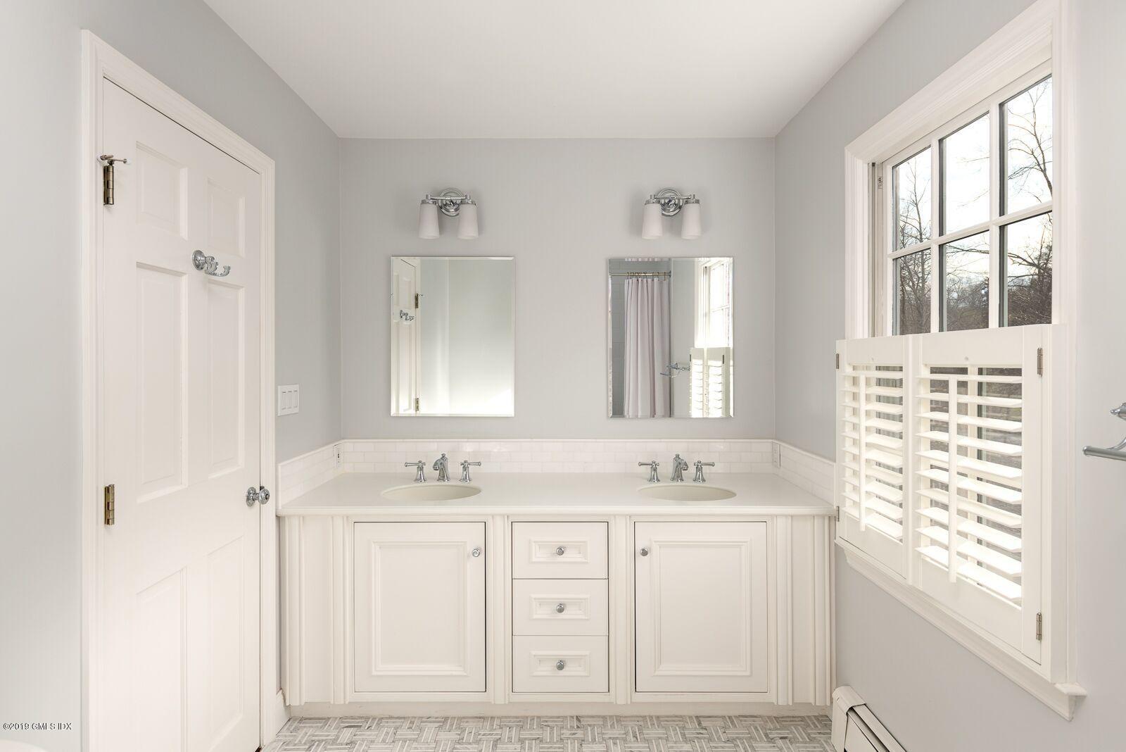 35 Copper Beech Road Greenwich, CT 06830 - Photo 17 of 26 a bathroom with a sink vanity and a mirror