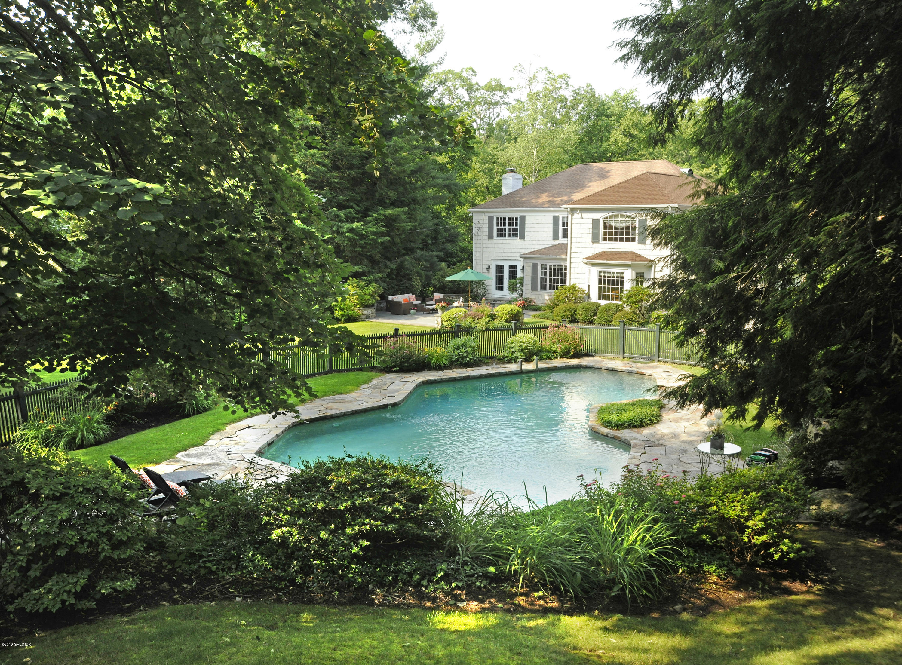 35 Copper Beech Road Greenwich, CT 06830 - Photo 22 of 26 a house with swimming pool in front of it