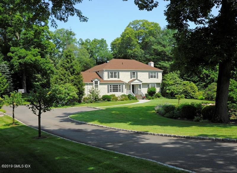 35 Copper Beech Road Greenwich, CT 06830 - Photo 24 of 26 a front view of a house with a yard